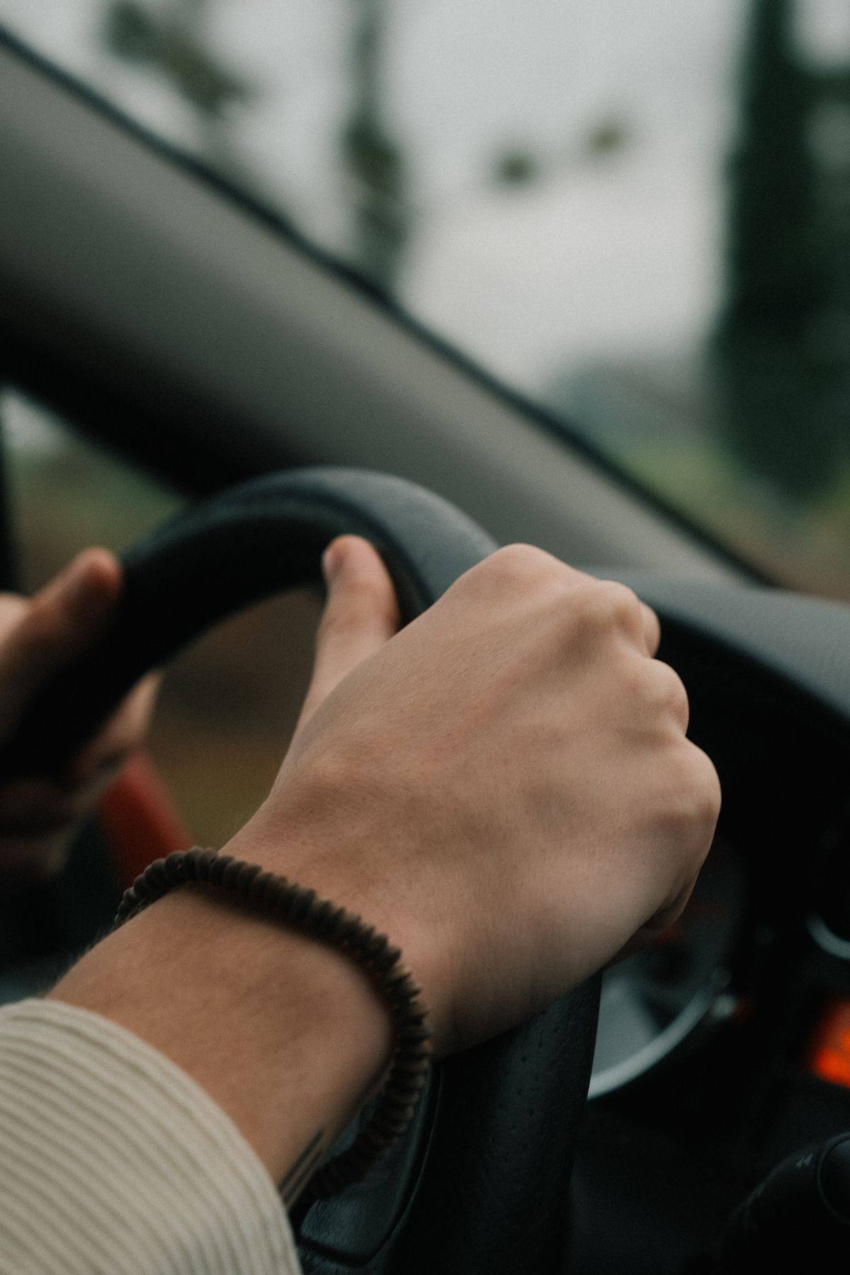 A driver's hands on the steering wheel